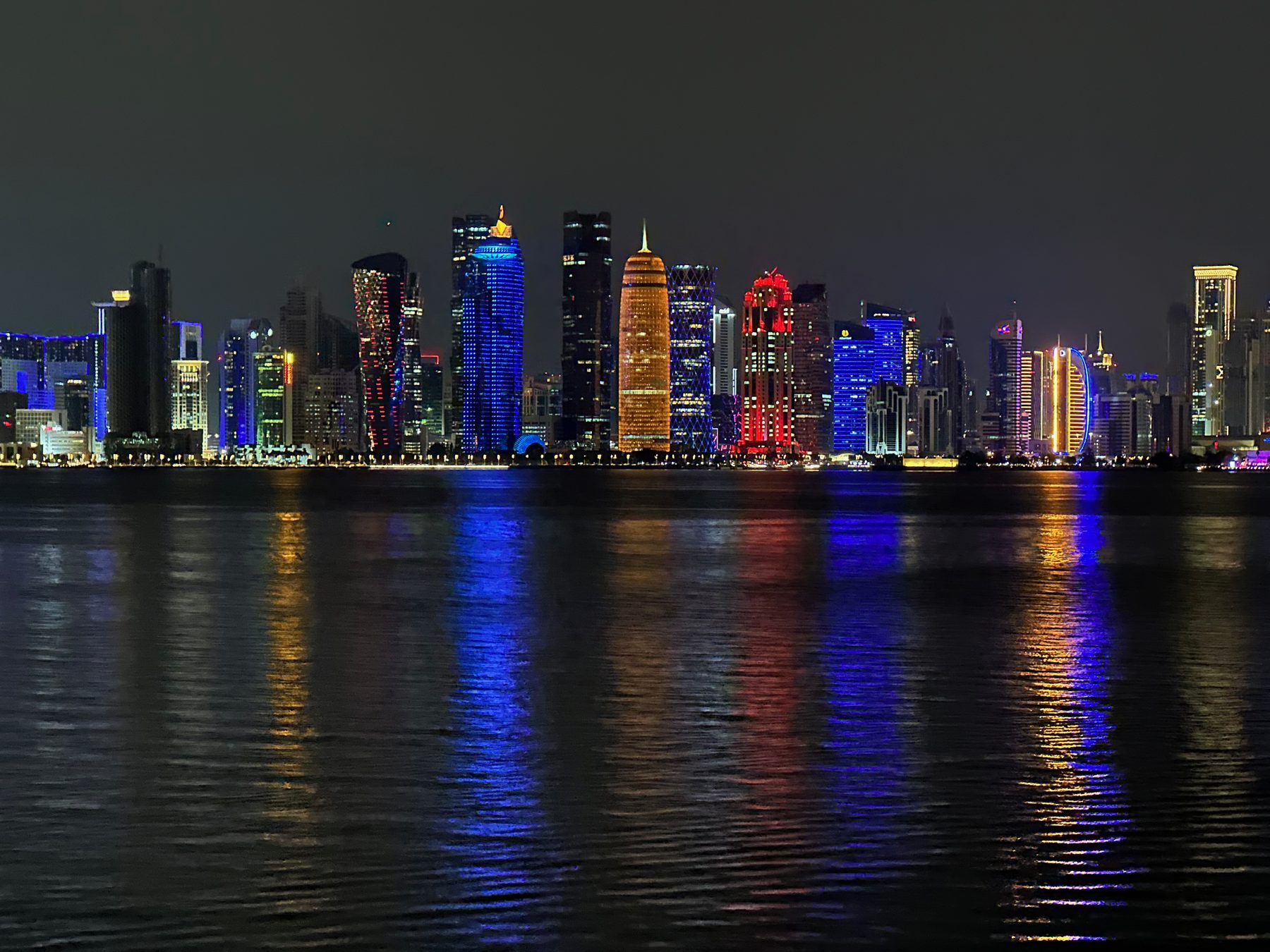 Doha skyline reflected in the bay at night
