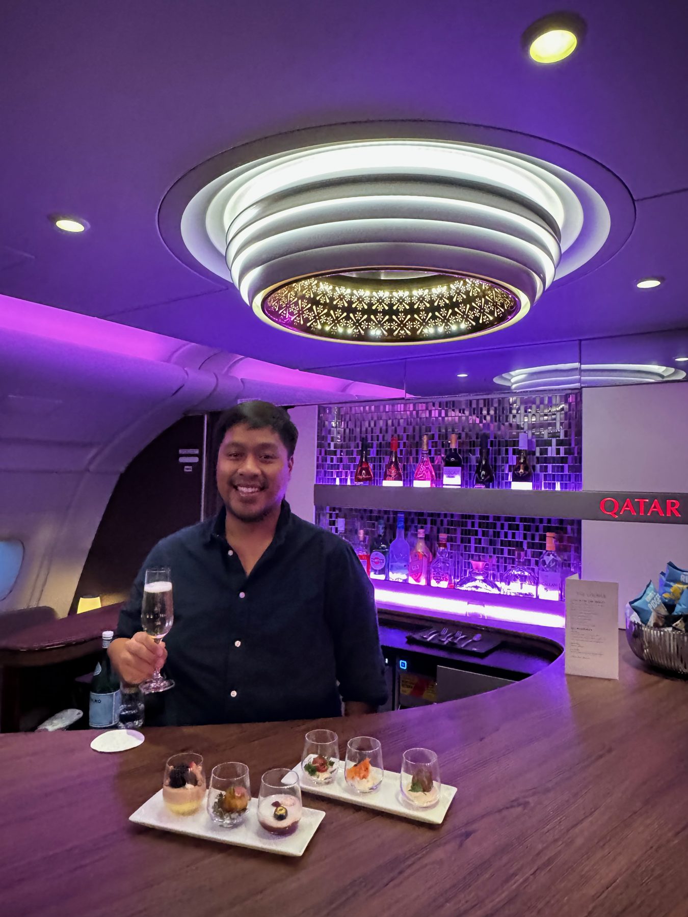 Erickson at the onboard bar of the Qatar Airways A380 with a tasting flight
